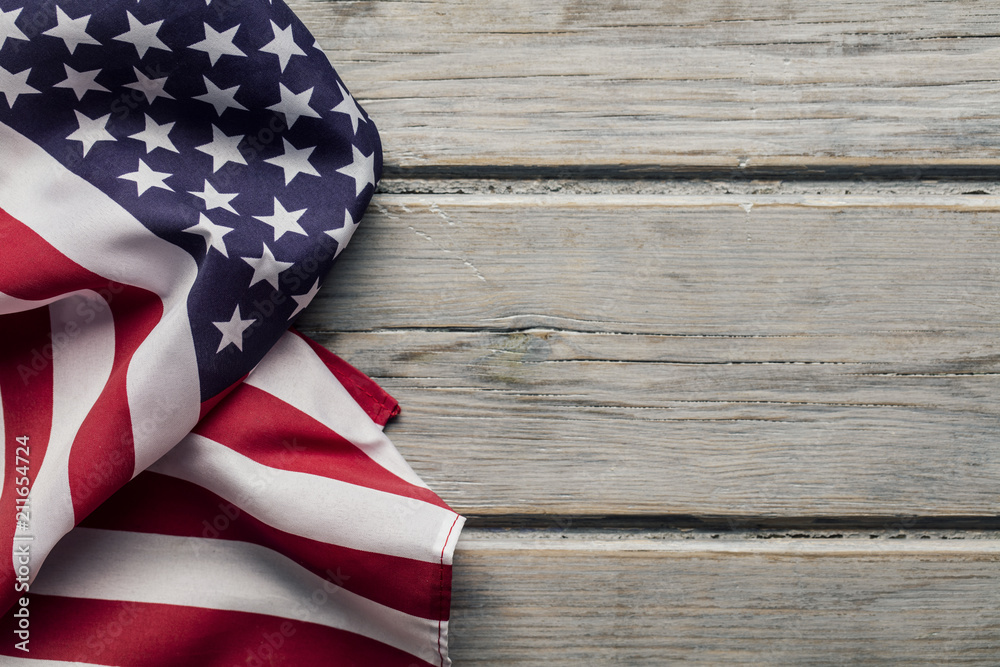 Obraz premium American stars and stripes flag on a white wooden plank background