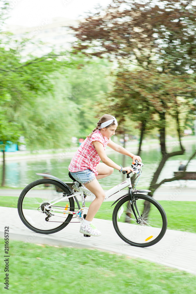 Girl riding her bicycle on park trails 