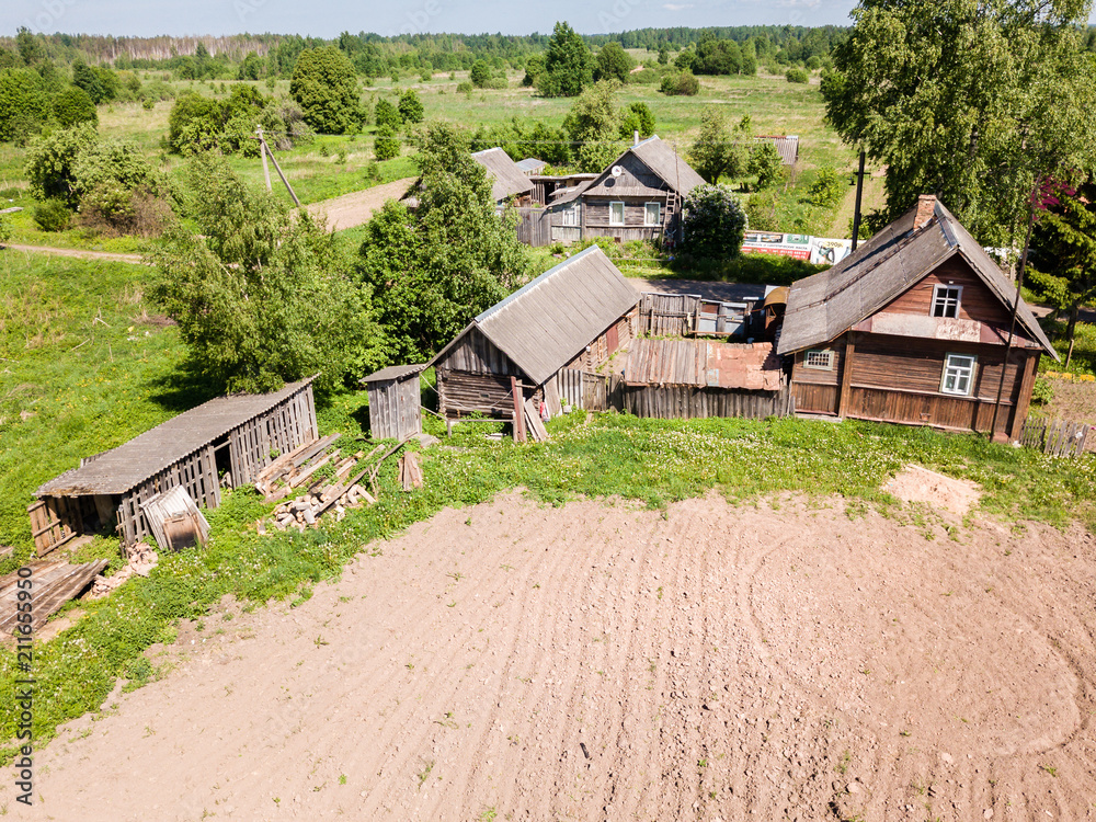 Obraz premium Aerial view of old wooden house in the small village on summer d