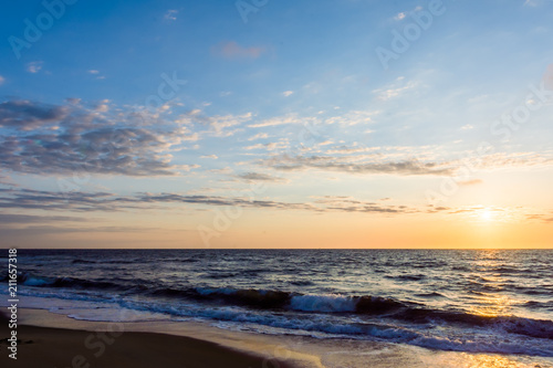 Beach sunrise or sunset with cloudy sky © Brett