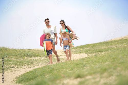 Family walking to the beach, sand dune path