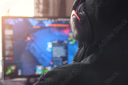 Back view of man playing PC game