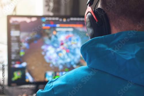 Back view of man playing PC game