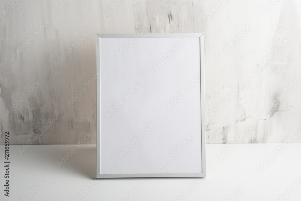 Empty white frame on the wall background. The concept of design and font inscriptions and image placement Empty white frame on the wall background. The concept of design and font inscriptions and image placement