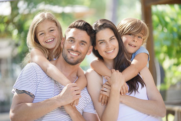 Portrait of happy family on summer day