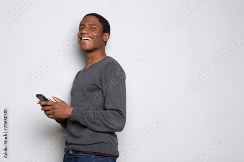 Profile happy african american man with cellphone against white background