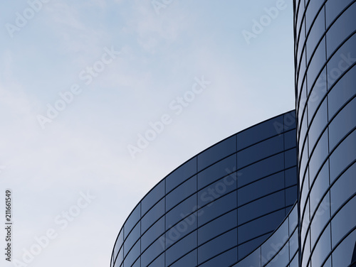 3D stimulate of high rise curve glass building and dark steel window system on blue clear sky background,Business concept of future architecture,lookup to the angle of the corner building.3d rendering