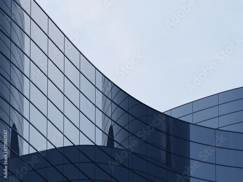 3D stimulate of high rise curve glass building and dark steel window system on blue clear sky background,Business concept of future architecture,lookup to the angle of the corner building.3d rendering