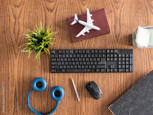 top view of woodenn businessman's desk concept, pot of grass, headphones, book  ,notes  photo