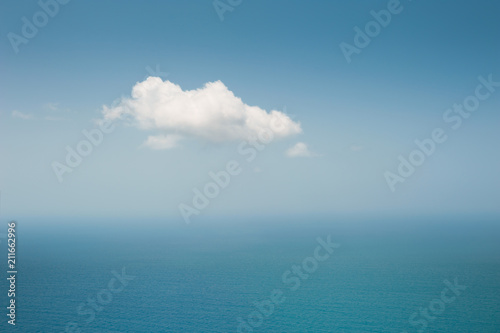 Lonely white cloud over the blue sea. Abstract nature background