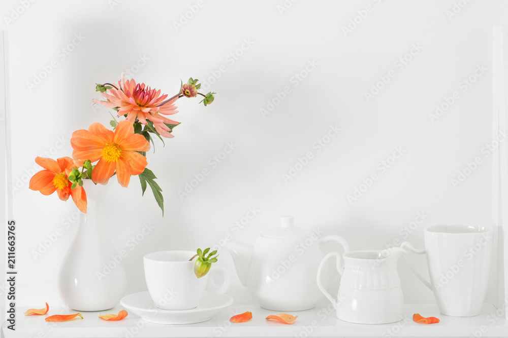 white dishvare with flowers on wooden shelf white dishvare with flowers on wooden shelf