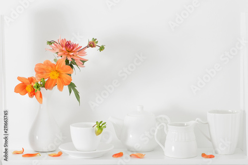 white dishvare with flowers on wooden shelf