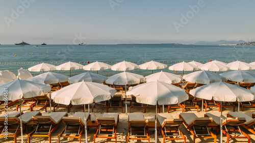 Rows of empty beach lounges and sun umbrellas on a beach in Juan les Pins, France