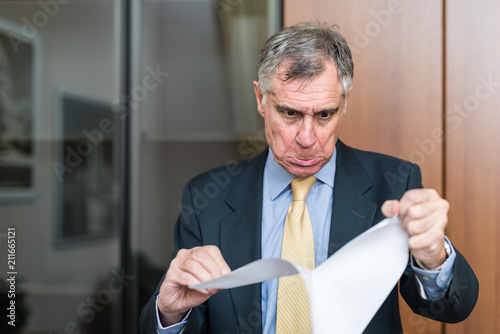 Photography Angry man destroying a document