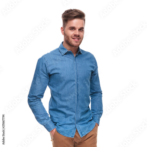 portrait of relaxed young casual man standing and smiling
