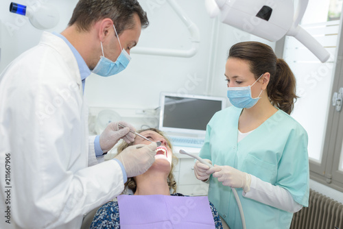 female patient receiving treatment from dentist