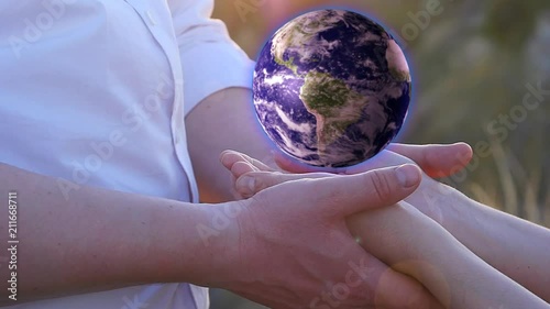 Male and female hands holding planet Earth