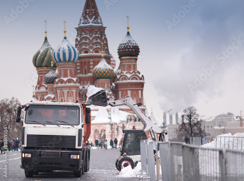 Canvas Print The skid-steer loader cleans, removes snow on the red square in moscow russia