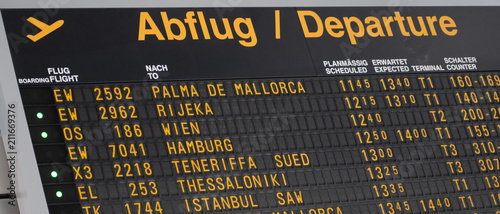 Airport flight information on a large screen international departure board