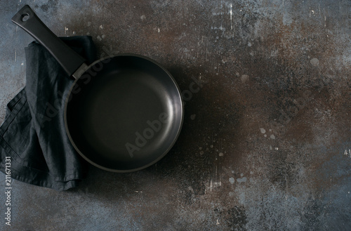 Empty iron pan on dark grunge background