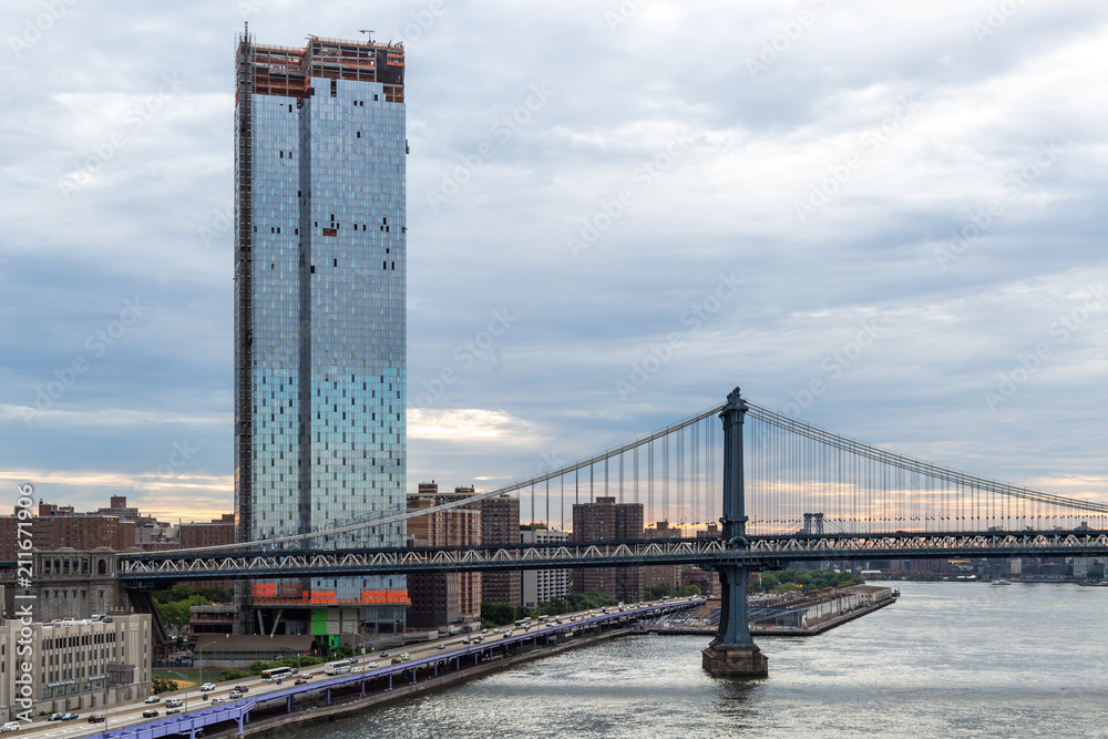 New York City / USA - JUN 20 2018: Manhattan Bridge with skyscraper and buildings at early morning in New York City