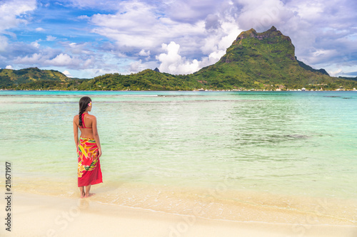 Canvas Print Tahiti luxury travel beach vacation woman walking in polynesian cover-up skirt beachwear on idyllic paradise island in French Polynesia