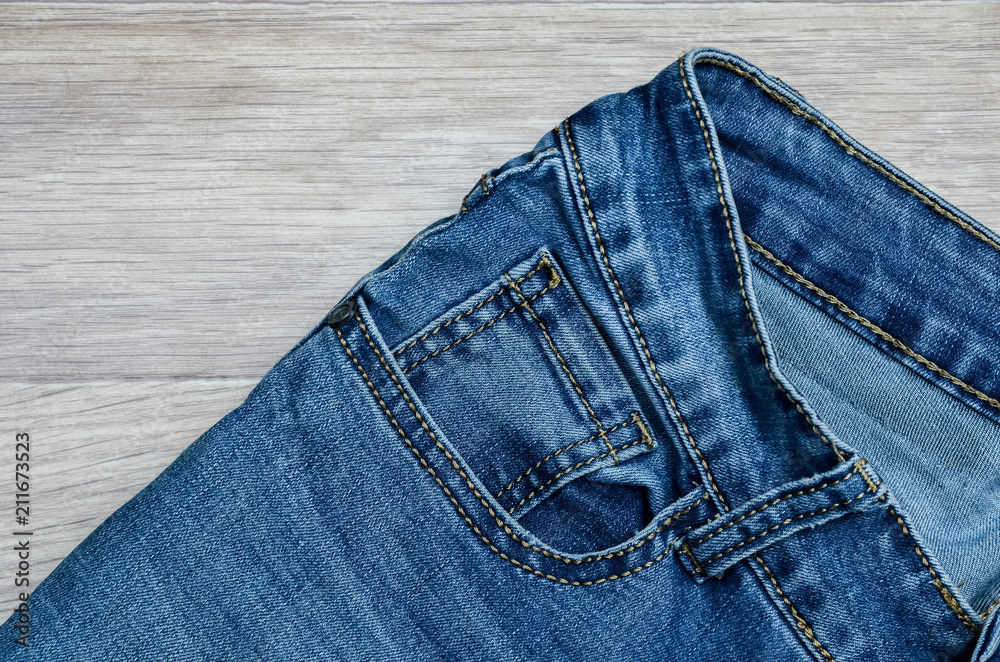 jeans on the background, blue jeans lie on a wooden background, jeans on the background, blue jeans lie on a wooden background,