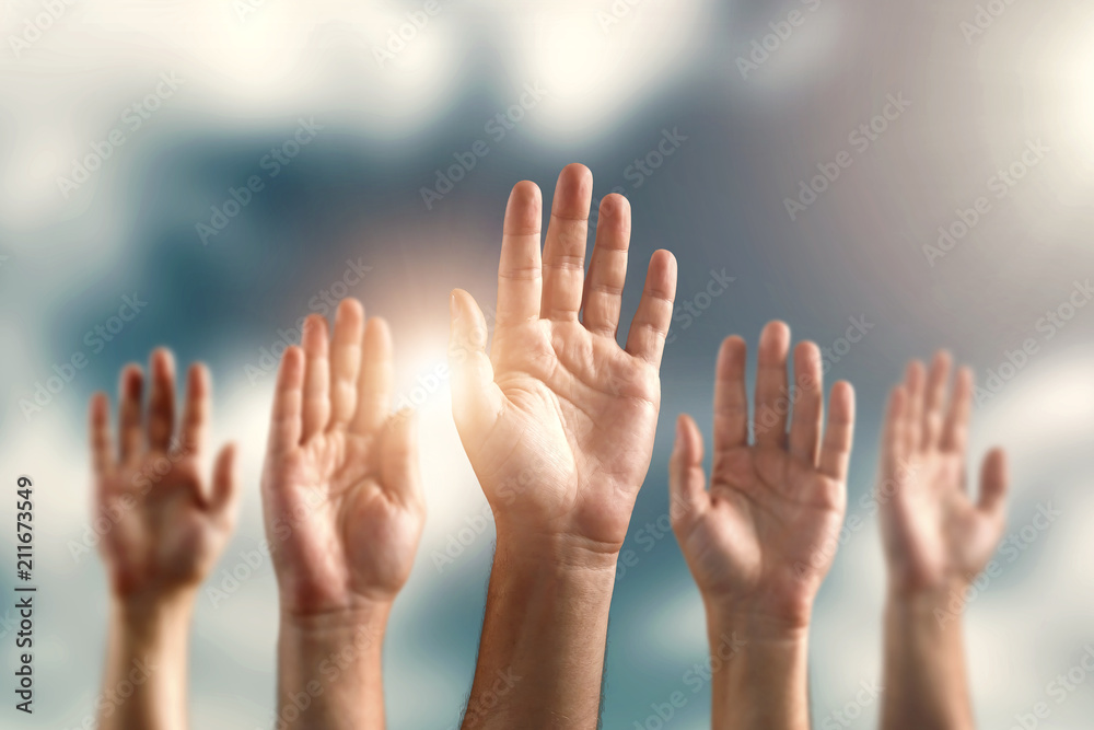 Many human hands, palms raised up against the sky. The concept of voting, free choice, own opinion, freedom of speech. Many human hands, palms raised up against the sky. The concept of voting, free choice, own opinion, freedom of speech.
