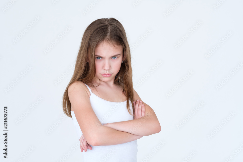 emotion face. child making a hurt look. offended capricious kid with her arms crossed. little girl portrait on white background. mood feelings personality and facial expression concept emotion face. child making a hurt look. offended capricious kid with her arms crossed. little girl portrait on white background. mood feelings personality and facial expression concept