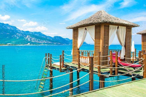 Wooden beach pavilions on the shore of a sandy beach photo