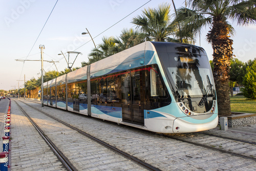 Perspective shot of tramway in movement with pedestrian stones at sunset time in Izmir at Turkey