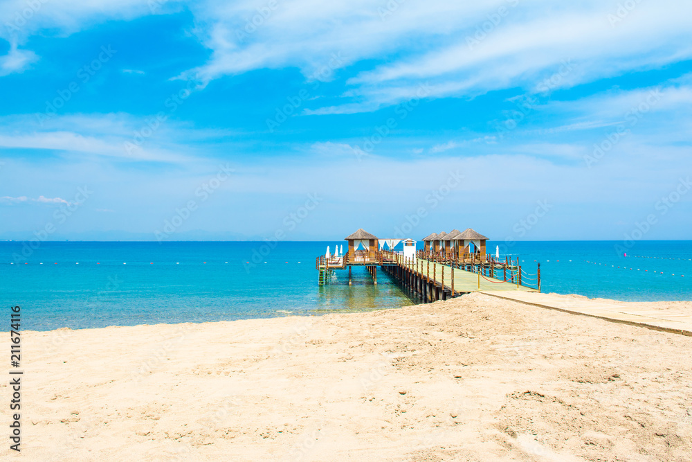 Wooden beach pavilions on the shore of a sandy beach