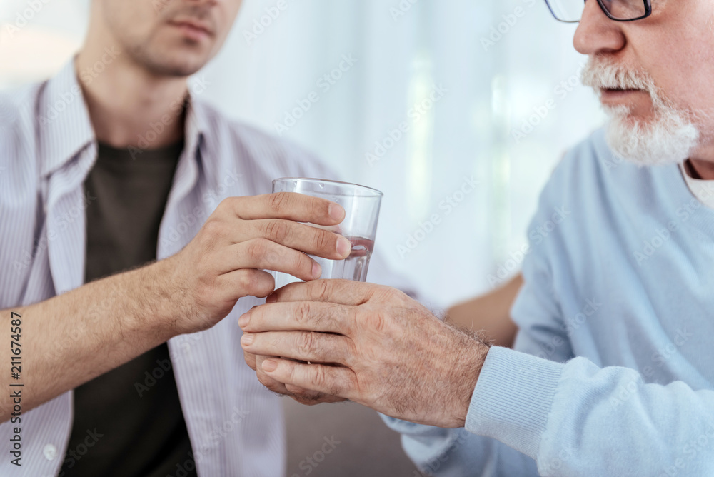 Clean water. Close up of fresh transport water filled in glass and male hands holding it Clean water. Close up of fresh transport water filled in glass and male hands holding it
