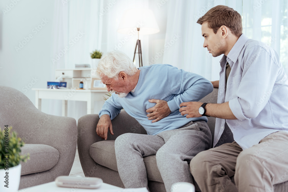 Myocardial infarction. Painful senior man touching chest and crying Myocardial infarction. Painful senior man touching chest and crying