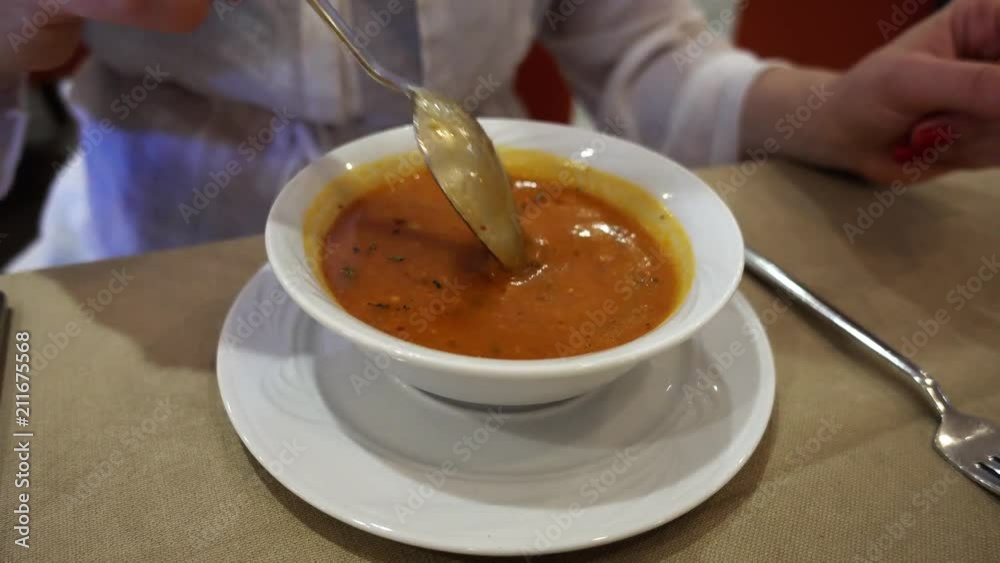 The girl is eating soup. Shooting close-up of a plate with soup. The girl is eating soup. Shooting close-up of a plate with soup.