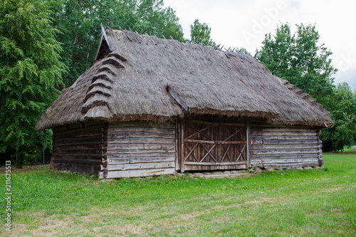 Barn with a thatched roof in a village in Poland 