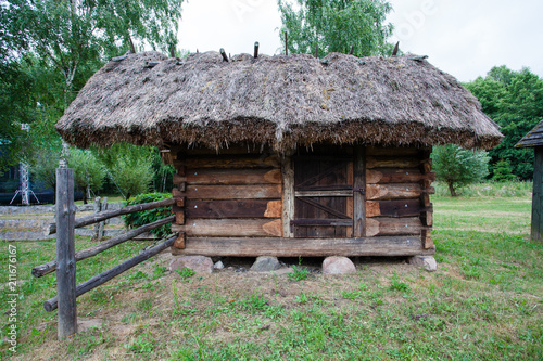 Barn with a thatched roof in a village in Poland