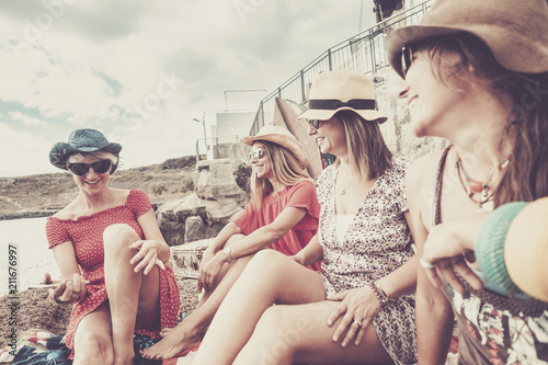 vintage style for group of females people stay together in friendship on vacation near the beach for summer leisure activiy. smiles and laughs for nbeautiful ladies outdoor photo