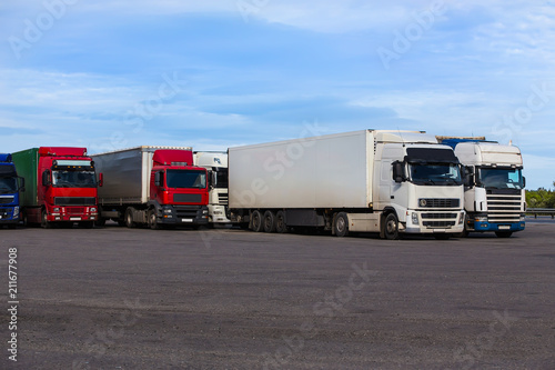 trucks in the Parking lot near the highway © Yuri Bizgaimer