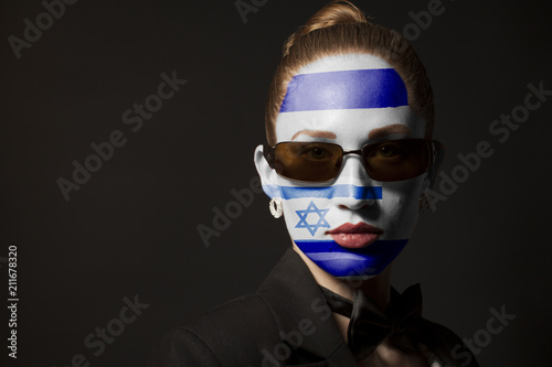 Portrait of woman with painted Israel flag and sunglasses
