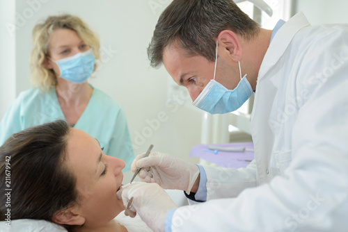 dentist inspecting the teeth