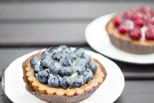 Sweet cake with berries on table close-up.