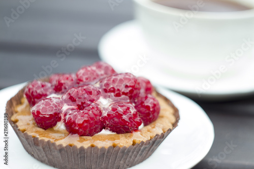 Sweet cake with raspberries on table close-up.