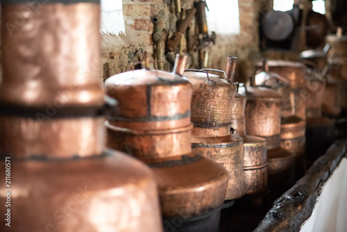 Copper utensils: frying pans, hanging from the ceiling in the kitchen
