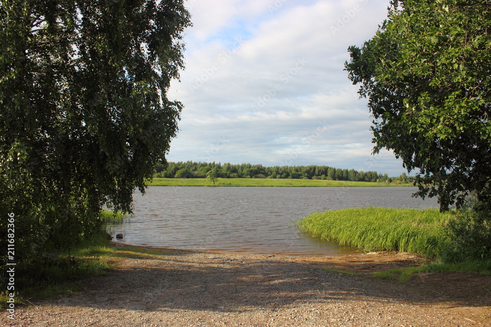 View from the shore to the slipway - sand slide for boats with trees at the edges