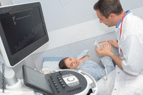doctor assuring the pregnant woman before the ultrasound