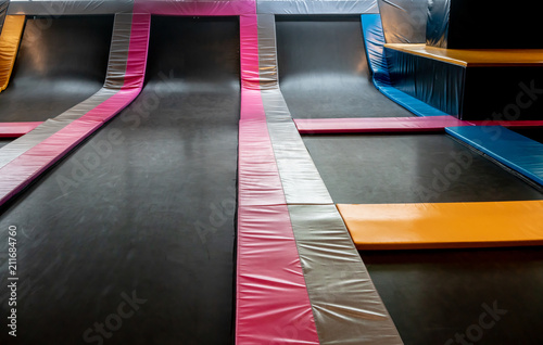 Interconnected trampolines for indoor jumping. New revolution playground and fun activity