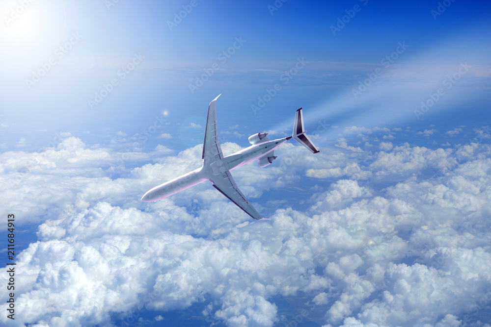Samolot odrzutowy nad chmurami schodzi do lądowania w promieniach słońca. - obrazy, fototapety, plakaty 
