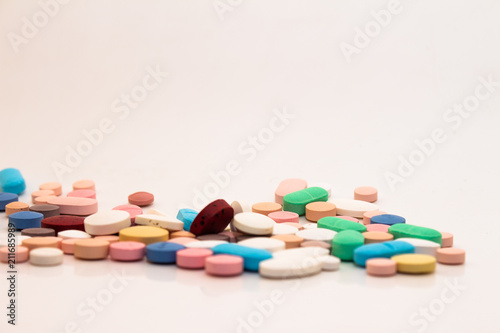 Numerous medicines Medications in the form of tablets. Colored pills on a white background.