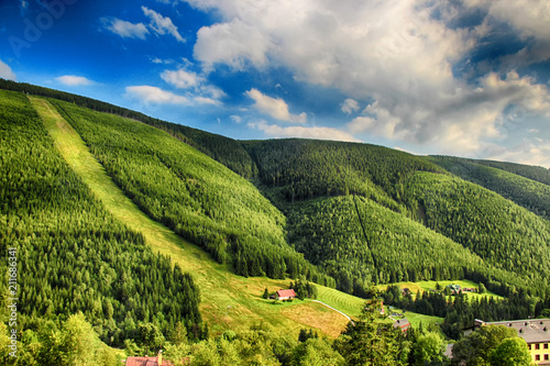 Valley in czech national park  Giant mountain- Krkonose. The town with a lot of wooden huts in Spindleruv Mlyn. Czech nature is beautiful. photo